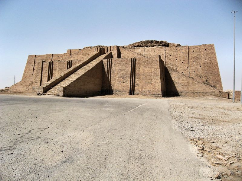 Photo of an massive ancient Mesopotamian temple known as a Ziggurat.  It is square, with a wide set of stairs, and is made of many thousands of building bricks.
