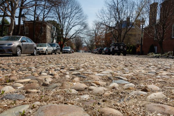Close up picture of Captain's Row, a street in Alexandria, Virginia, made from natural cobblestone pavers.
