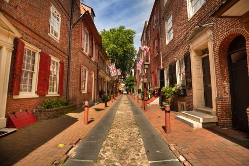 Elfreth's Alley, in Philadelphia.  A narrow road, with old brick buildings on both sides.  Granite runners surrounding a thin middle strip of cobblestone pavers.