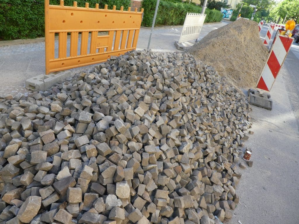A picture of a pile of European cobblestones which have been removed from a busy street in Rome.  They are destined to be reset on quieter streets with less traffic.