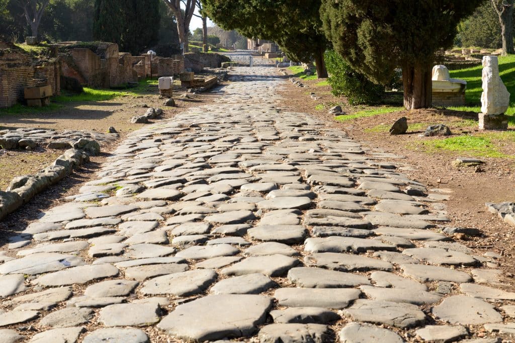 A picture of an ancient Roman road, still in tact today.  It shows how the Romans built their roads higher in the center, so rainwater could run off to the sides.
