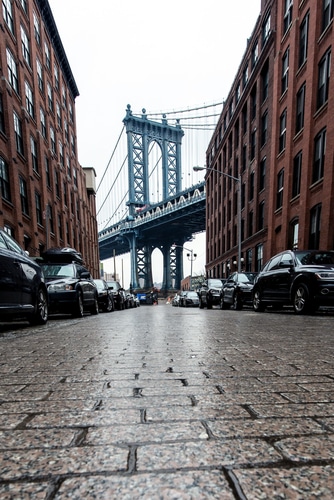 The cobblestone pavers on Water Street in Brooklyn, NY.  The Manhattan Bridge in the background.