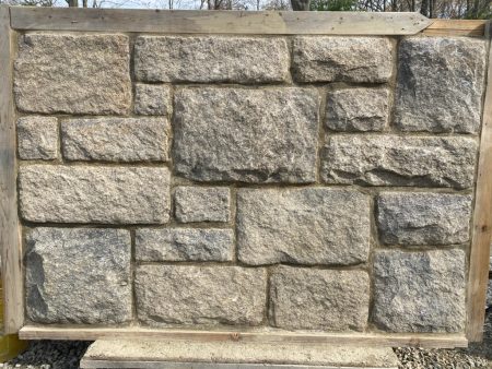 A mock-up of antique stone veneer, framed in wood.