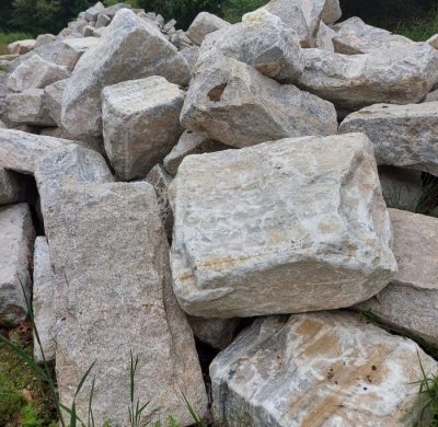 Reclaimed full bed stone veneer pieces lying in a pile.