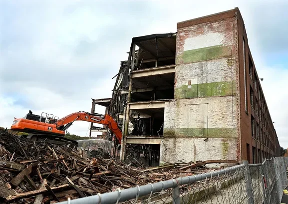 A building from the Draper Mill complex being demolished.