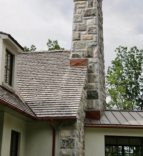 Image shows source of stone veneer - chimney stone being reclaimed