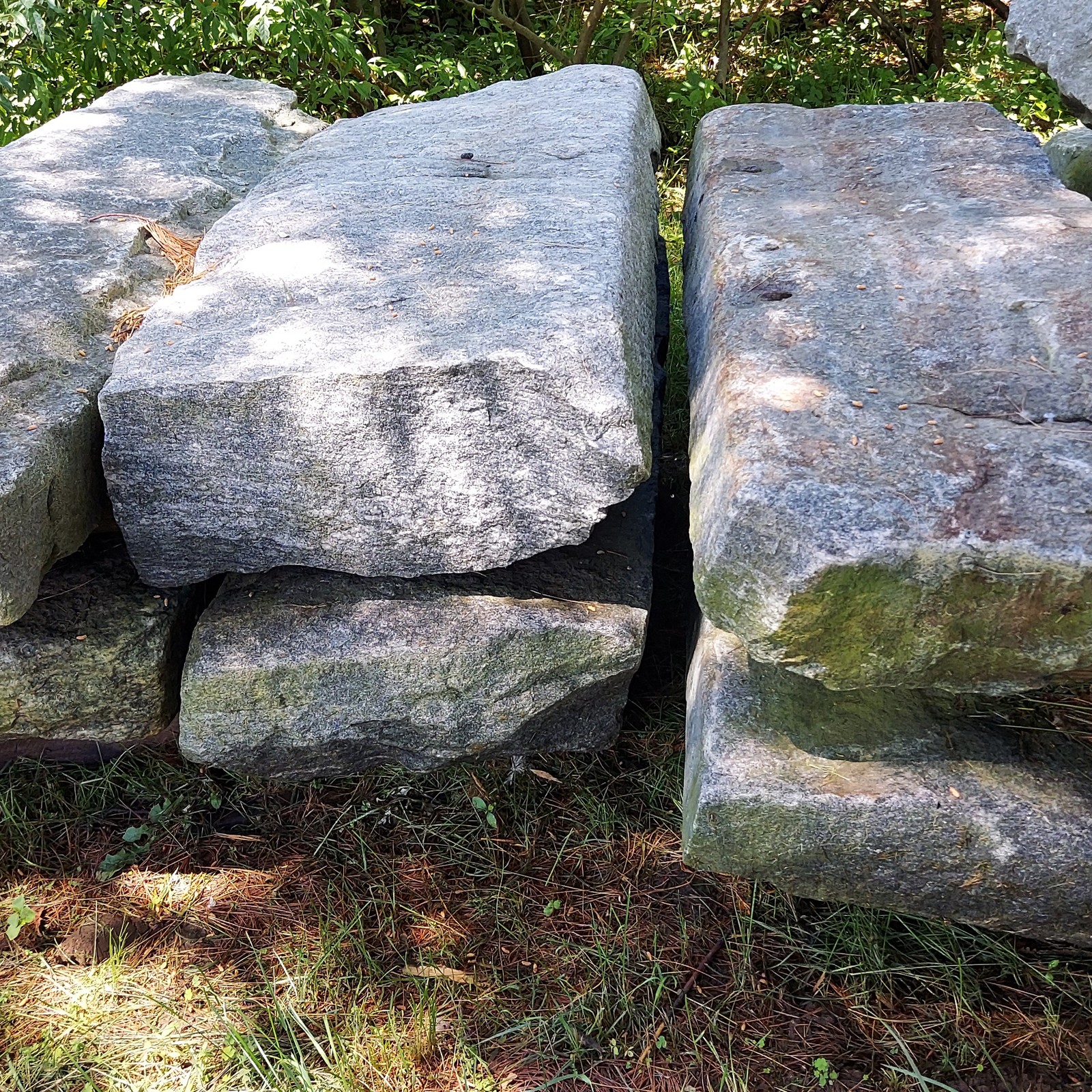 first generation reclaimed granite curbing pieces lined up in stacks of two pieces