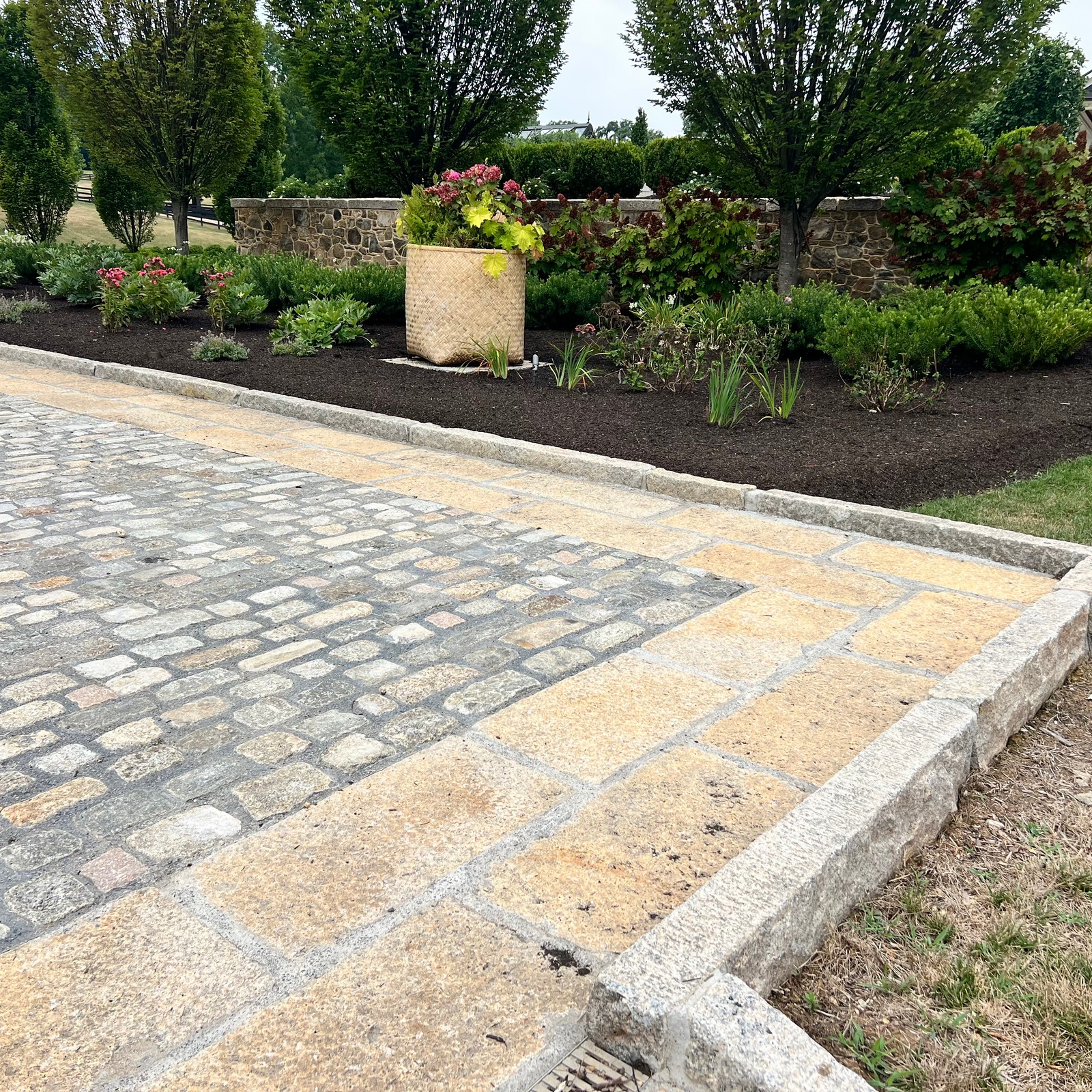 reclaimed granite curbing stood up and used for a driveway border