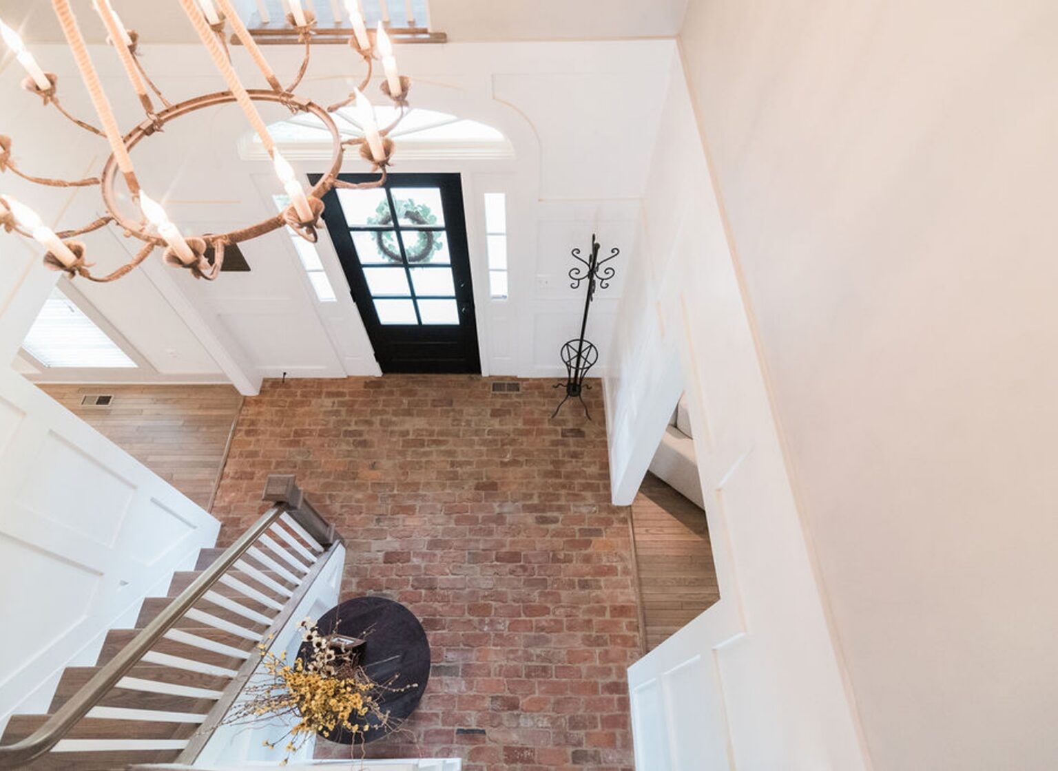 Foyer with a reclaimed brick tile floor.