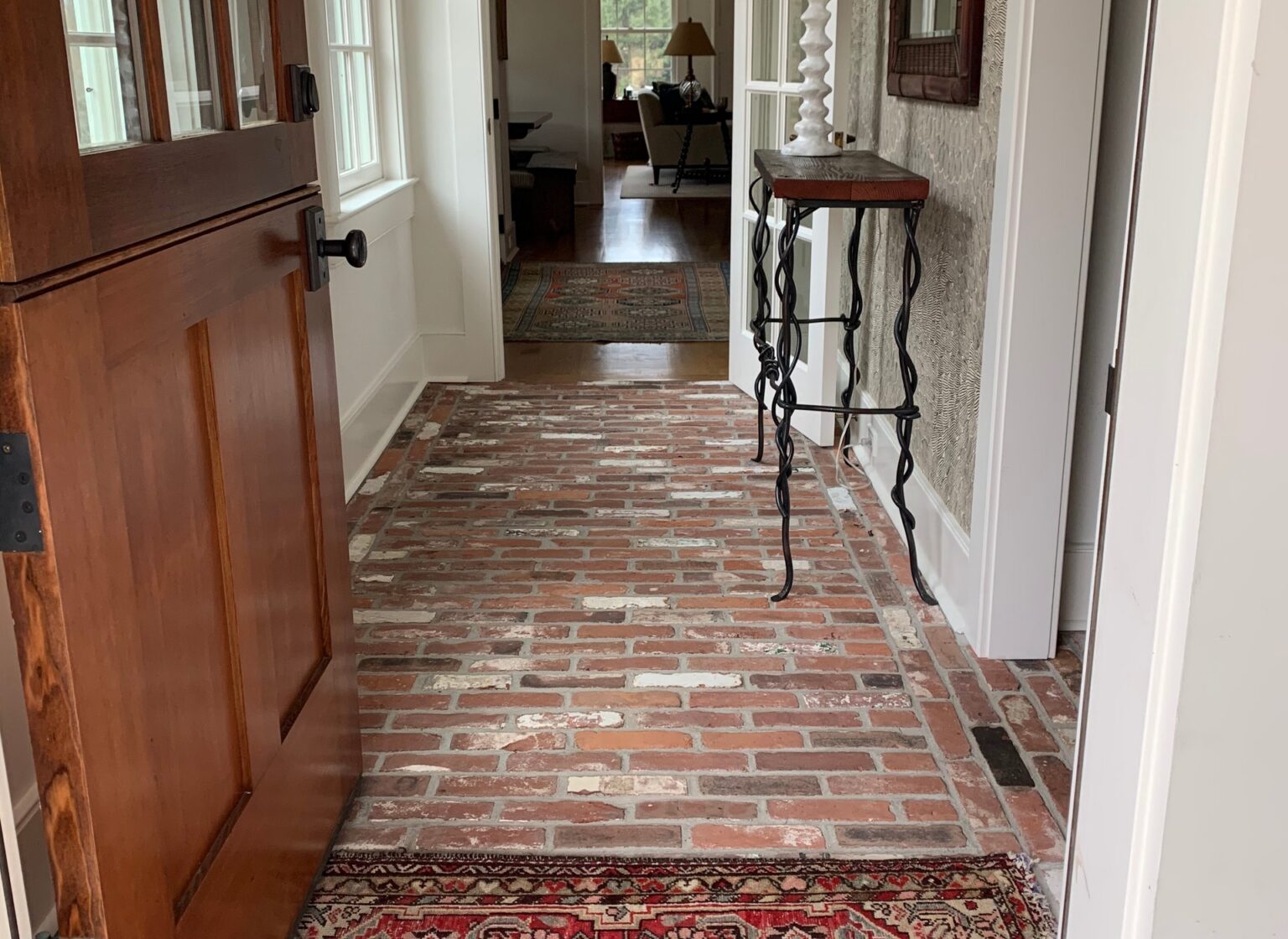 Mudroom with reclaimed brick floor.