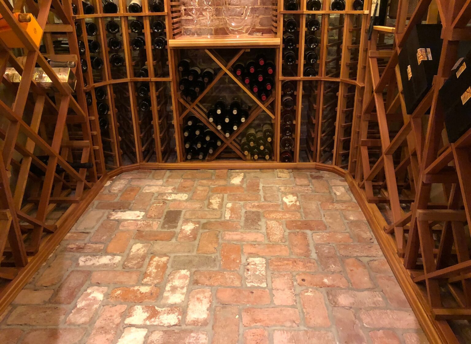 Wine cellar with reclaimed brick floor.