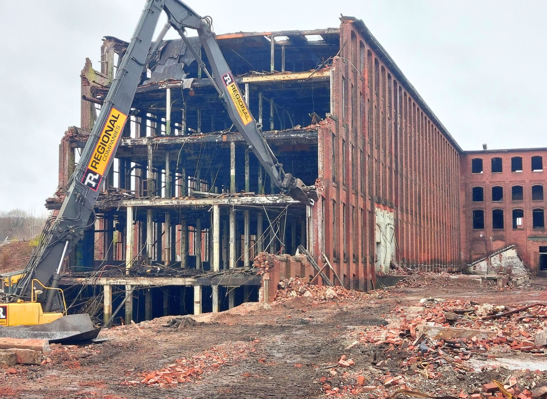 Historic brick mill being carefully demolished so its brick can be salvaged